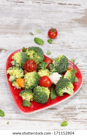 Vegetables. Raw vegetable in heart shaped plate. Diet concept. Macrobiotic.