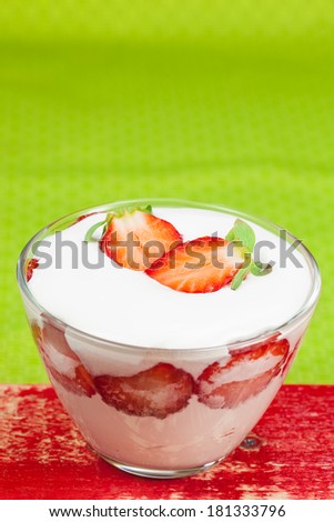 Strawberry Mousse. Strawberry mousse in a glass decorated with sliced strawberries for a dessert. Macro, selective focus