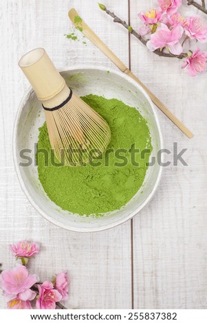 Green  tea . Still life with green tea powder and bamboo whisk. Japanese Tea Ceremony: Preparation of powdered green tea