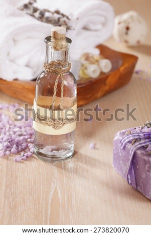 Lavender spa treatment. Various objects and beauty products on the wooden board. A macro photograph with  shallow depth of field. Natural light
