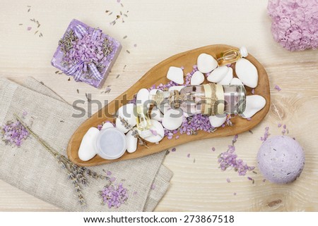 Lavender spa set on linen.  Various products, facial and body massage oils for spa treatment