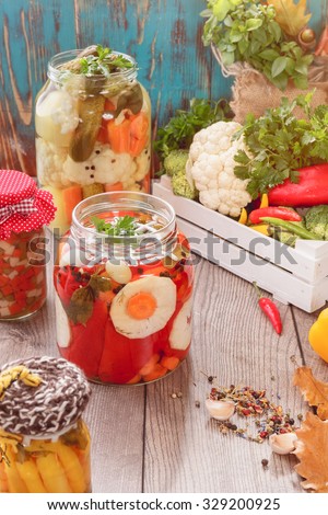 Assorted mixed vegetables in preserving jars. Still life with bottled and pickled vegetables in preserving jars. Vintage style
