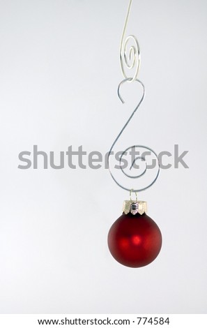 Red Ornament Hanging Against White