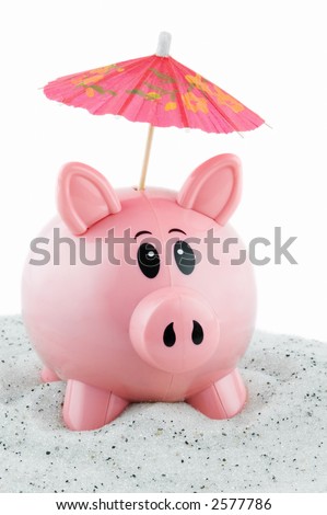 Piggy bank sits in sand with umbrella sticking out of coin slot