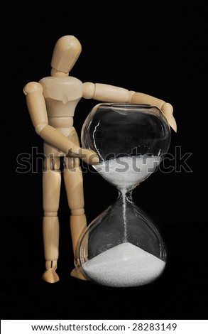 Watching Time Pass - Mannequin hold glass hourglass with white sand on black