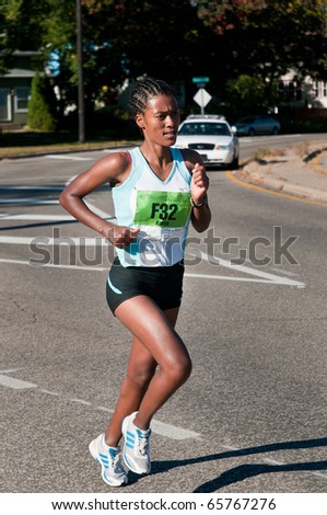 MINNEAPOLIS, MN - OCTOBER 3: Serkalem Abrha runs past the Mile 19 marker & goes on to finish 2nd in the Women\'s Division of the 2010 Medtronic Twin Cities Marathon, October 3, 2010 in Minneapolis, MN