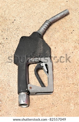 Old Gasoline Pump Nozzle - no hose, on concrete