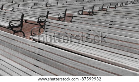 Benches - rows and rows of grey wooden benches