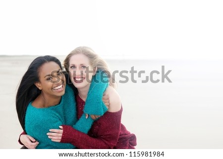 Two women laughing and smiling outdoors