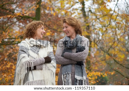 Portrait of two older women smiling outdoors