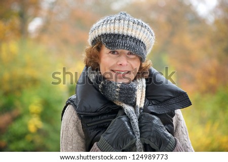 Portrait of a beautiful older woman smiling in the park
