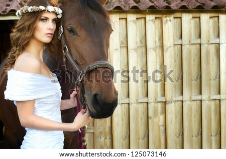 Horizontal portrait of a beautiful bride and horse