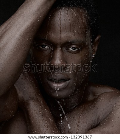 Close up portrait of an African American man with water dripping down face