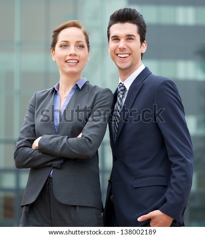 Portrait of a relaxed businessman and business woman smiling