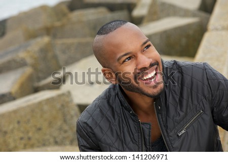 Portrait of a handsome black man smiling outdoors