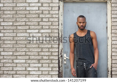 Portrait of an attractive male fashion model standing outdoors