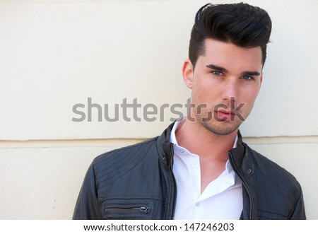 Portrait of a handsome young man in black leather jacket