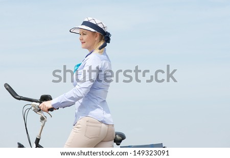 Closeup portrait of a woman with bicycle outdoors - copy space
