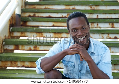 Portrait of an african american man smiling outdoors with happy expression on his face
