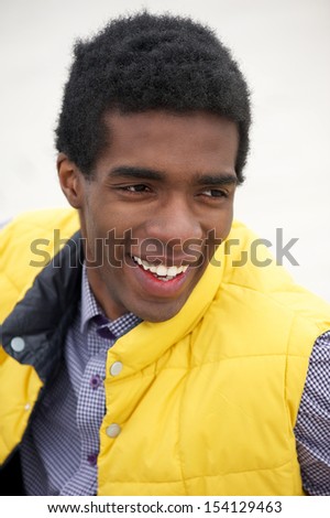 Closeup portrait of a young black man with happy expression on face