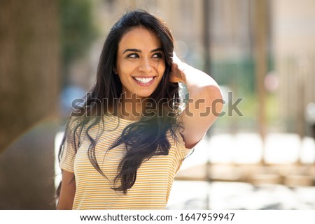 Similar – Image, Stock Photo Cheerful Arab woman with headphones on embankment