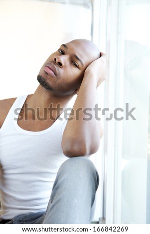 Close up portrait of a young man relaxing by window