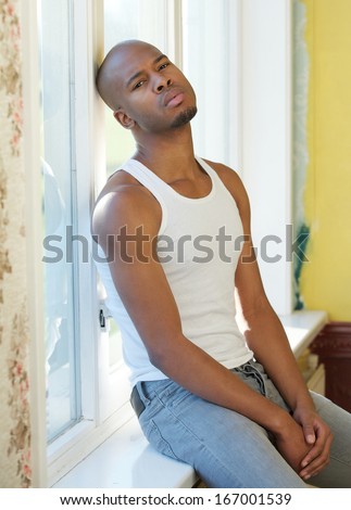 Close up portrait of a handsome man sitting by window in contemplation
