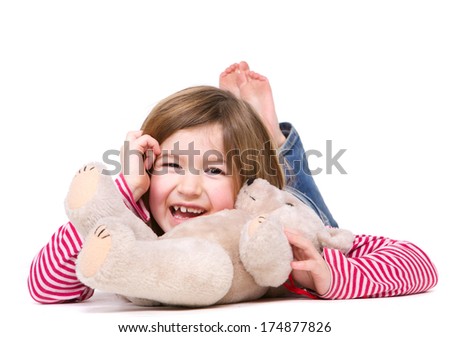Close up portrait of a young girl laughing with teddy bear on isolated white background