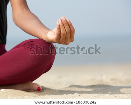Close-up of female hands rolling out beige yoga mat. Yoga Home