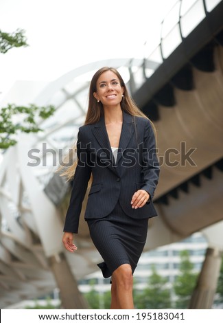 Portrait of a modern business woman walking in the city