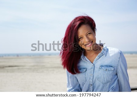 Portrait of a young woman smiling at the beach