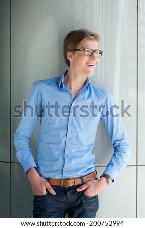 Portrait of a cool young guy smiling with glasses