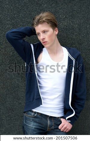 Portrait of a male fashion model posing with hand in hair