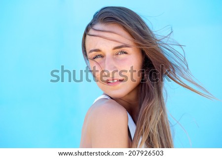 Close up portrait of a beautiful young woman with hair blowing