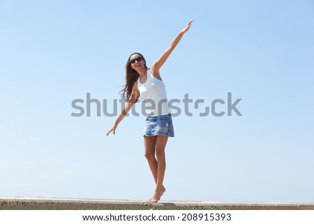 Portrait of a young woman balancing walk walking outdoors