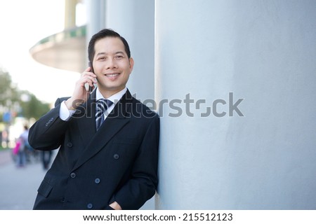 Close up portrait of a smiling businessman calling with cellphone
