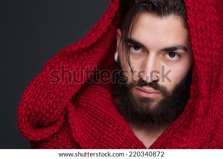 Close up portrait of a cool man with beard and red scarf
