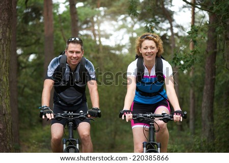 Portrait of a man and woman cyclist smiling outdoors