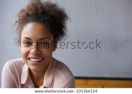 Close up portrait of a happy young black woman smiling