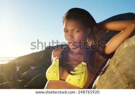 Close up portrait of a young african american woman posing in bikini at the beach
