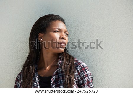 Close up portrait of an attractive black woman posing against white background
