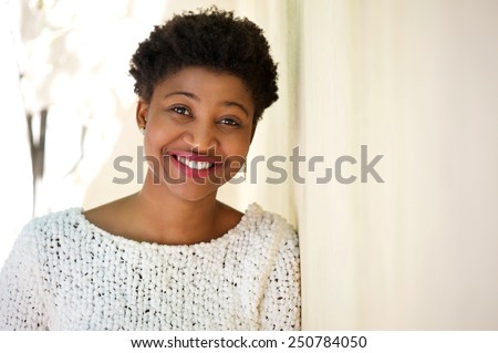 Close up portrait of a confident young black woman smiling