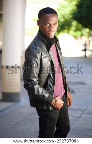 Portrait of a black male fashion model posing in leather jacket