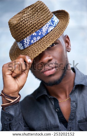 Close up portrait of a cool male african american fashion model with hat