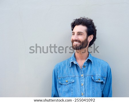 Close up happy man with beard smiling on grey background