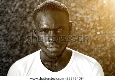 Close up black and white portrait of an african american man dripping with sweat