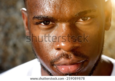 Close up portrait of a young sports man with dripping sweat on face