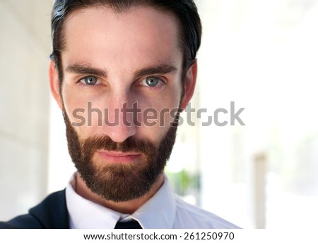 Close up portrait of a confident young man with beard