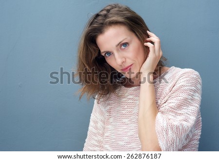 Close up portrait of an attractive woman posing with hand in hair