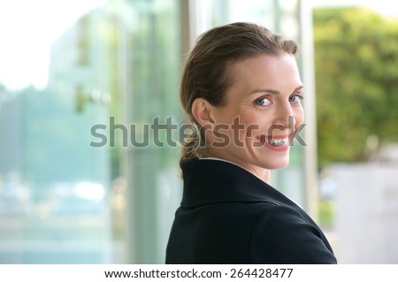 Close up portrait of a friendly career woman smiling outside